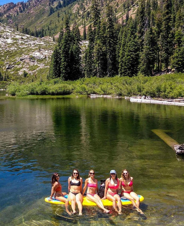 woman sitting on a paddle board