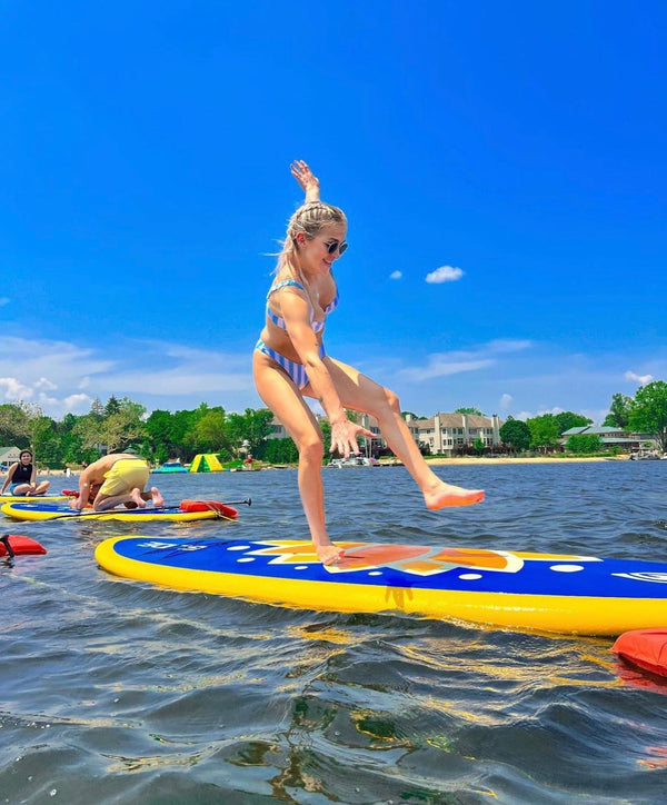 woman falling from paddle board