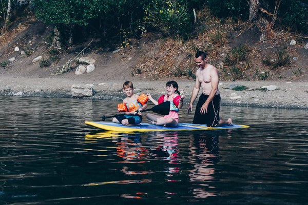 family on a paddle board