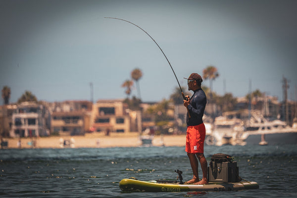 man fishing on paddle board