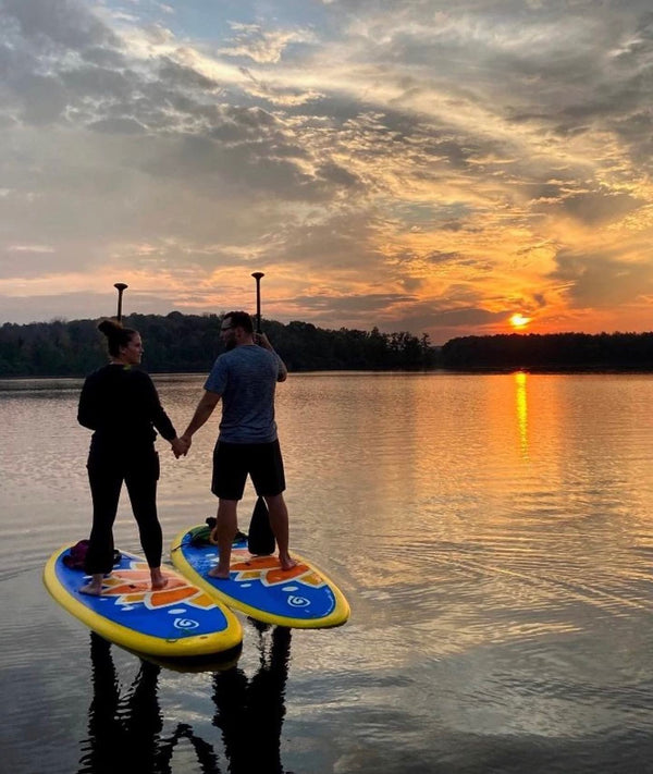 holding hands on paddle boards