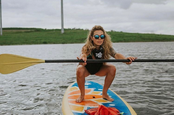 squatting on a paddle board