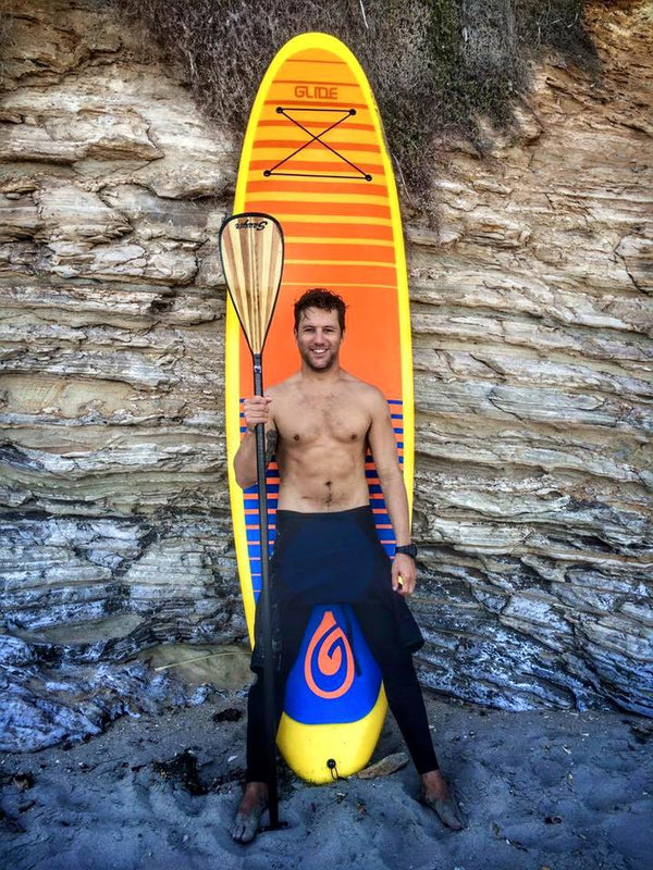 man in front of paddle board