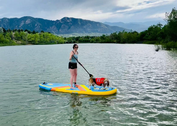 woman and dog on paddle board