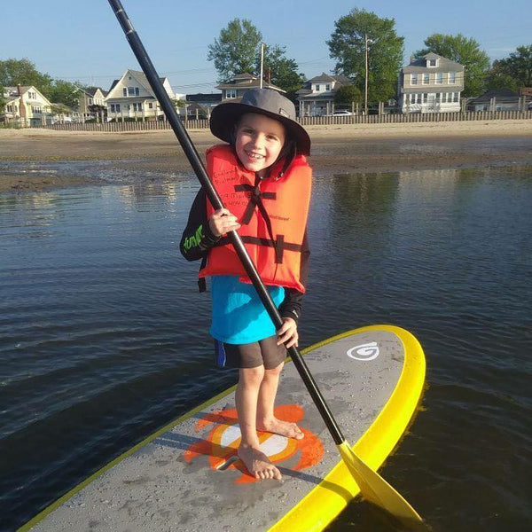 child on paddle board