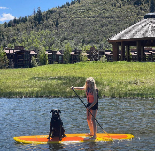 woman and do on paddle board