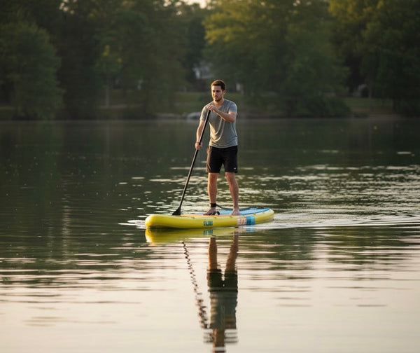 man paddling inflatable paddle board
