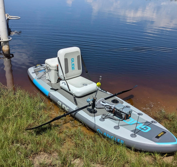 inflatable fishing paddle board with seat rod holder and gear setup on water