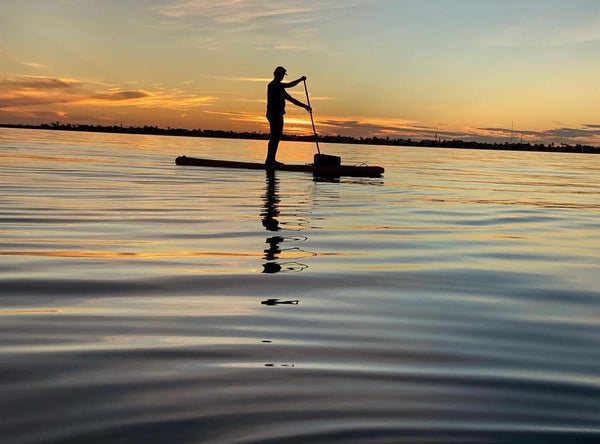 paddle board at sunset