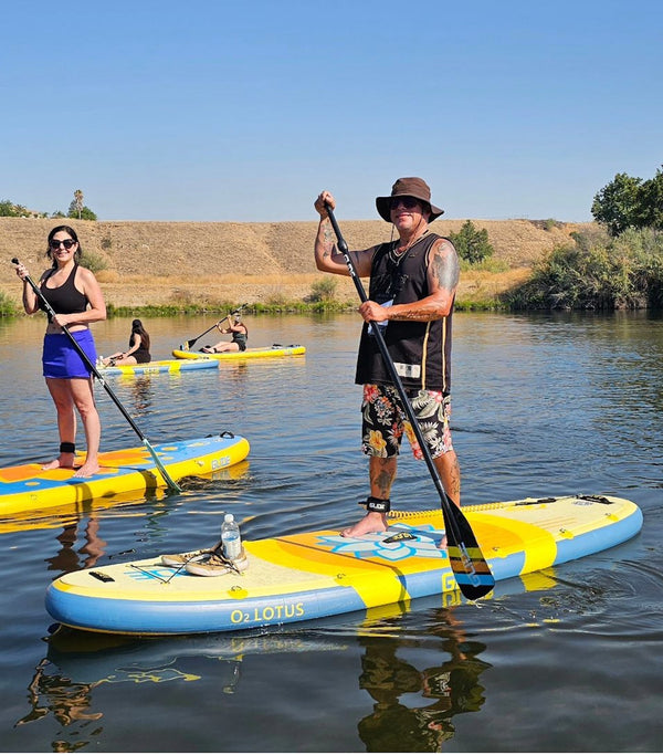 man and woman paddling paddleboards